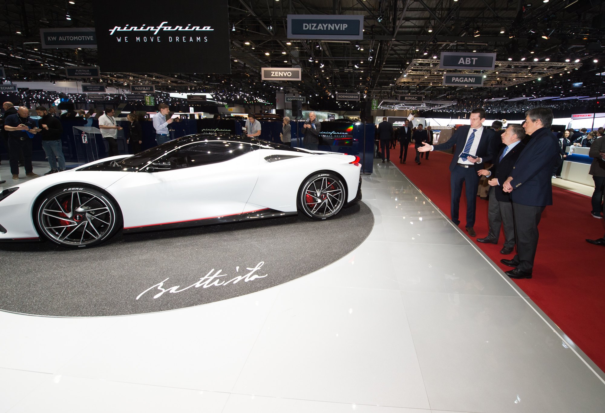 New cars under the lights on a motor show floor